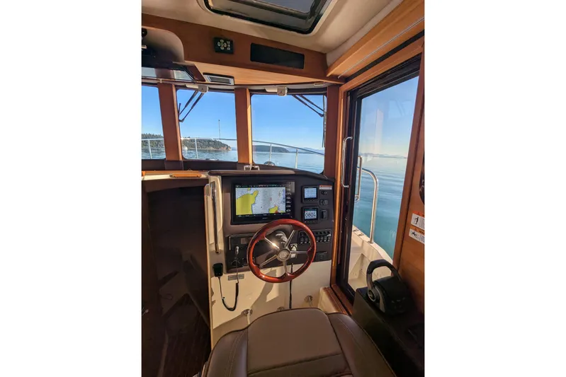 Lone Star Yacht Photos Pics Interior view of 2022 Ranger Tugs R-31 S helm with navigation equipment and ocean view.