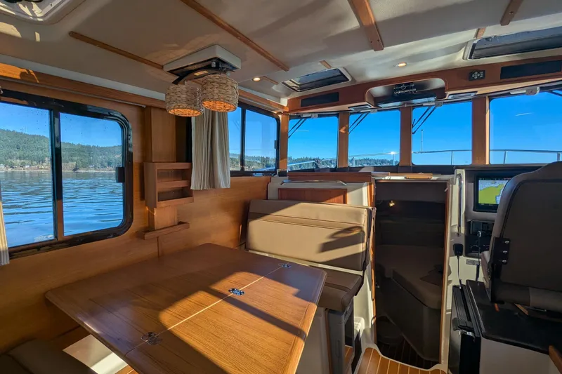 Lone Star Yacht Photos Pics Interior of 2022 Ranger Tugs R-31 S boat with wood finish and scenic window views.