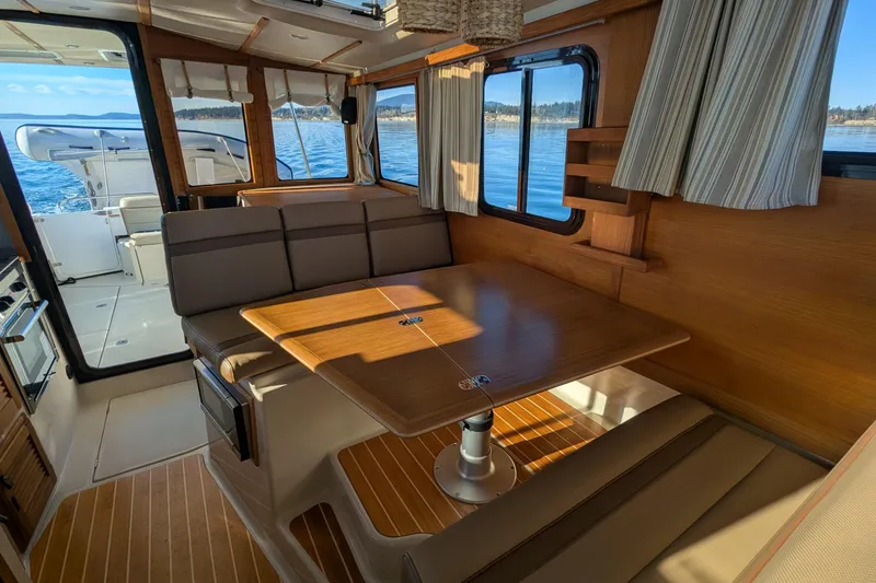 Lone Star Yacht Photos Pics Interior of 2022 Ranger Tugs R-31 S with dining area and scenic ocean view.