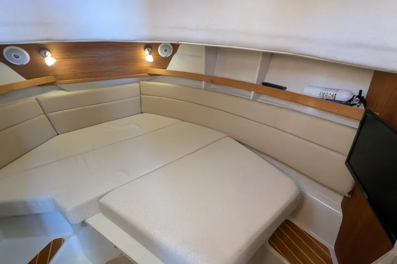 Lone Star Yacht Photos Pics 2022 Ranger Tugs R-31 S interior cabin with beige seating and wooden accents.