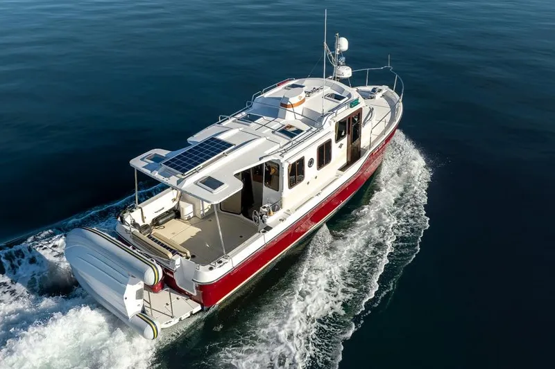 Lone Star Yacht Photos Pics 2022 Ranger Tugs R-31 S cruising on open water, showcasing sleek design and solar panels.