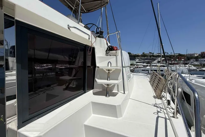 Raf IV Yacht Photos Pics 2020 Bali 4.3 catamaran deck view with marina background, showcasing sleek design and spacious layout.