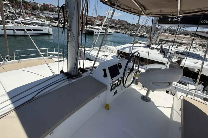 Raf IV Yacht Photos Pics Helm of 2020 Bali 4.3 catamaran in marina, surrounded by yachts and calm water.