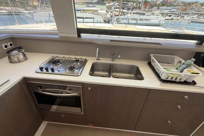 Raf IV Yacht Photos Pics Modern kitchen in a 2020 Bali 4.3 yacht with stove, sink, and sea view.