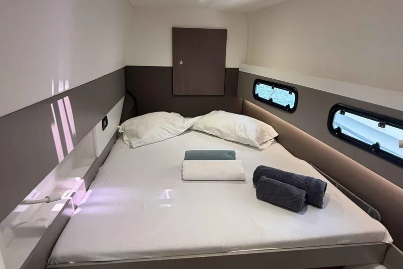 Raf IV Yacht Photos Pics Cozy cabin interior of 2020 Bali 4.3 yacht with neatly arranged bed and towels.