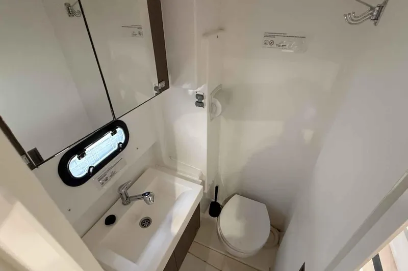 Raf IV Yacht Photos Pics Compact bathroom in 2020 Bali 4.3 model, featuring sink, toilet, and mirror.