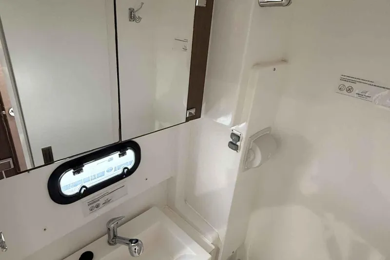 Raf IV Yacht Photos Pics Compact bathroom in 2020 Bali 4.3 yacht with sink, mirror, and porthole window.