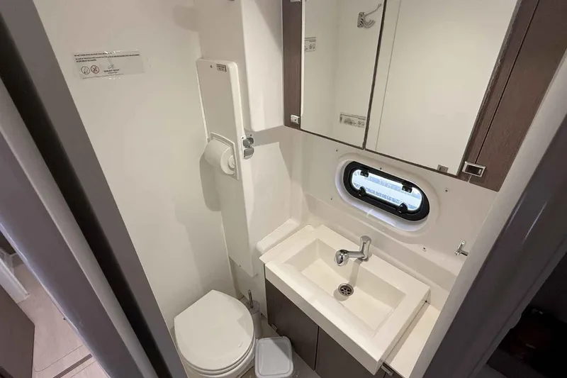 Raf IV Yacht Photos Pics Compact bathroom in 2020 Bali 4.3 yacht with sink, toilet, and porthole window.