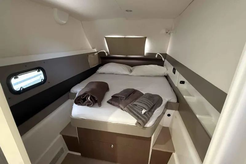 Raf IV Yacht Photos Pics Cozy cabin interior of 2020 Bali 4.3 yacht with neatly arranged bed and towels.