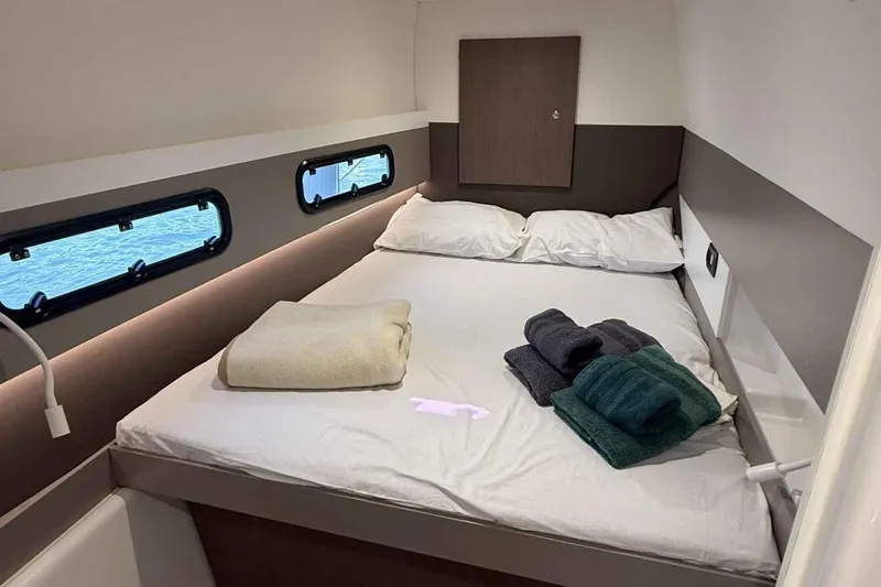 Raf IV Yacht Photos Pics Cozy cabin interior of 2020 Bali 4.3 yacht with bed and porthole views.