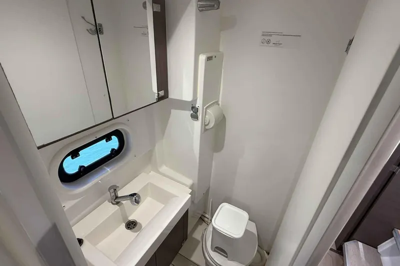 Raf IV Yacht Photos Pics Compact bathroom in a 2020 Bali 4.3 yacht, featuring a sink, mirror, and toilet.