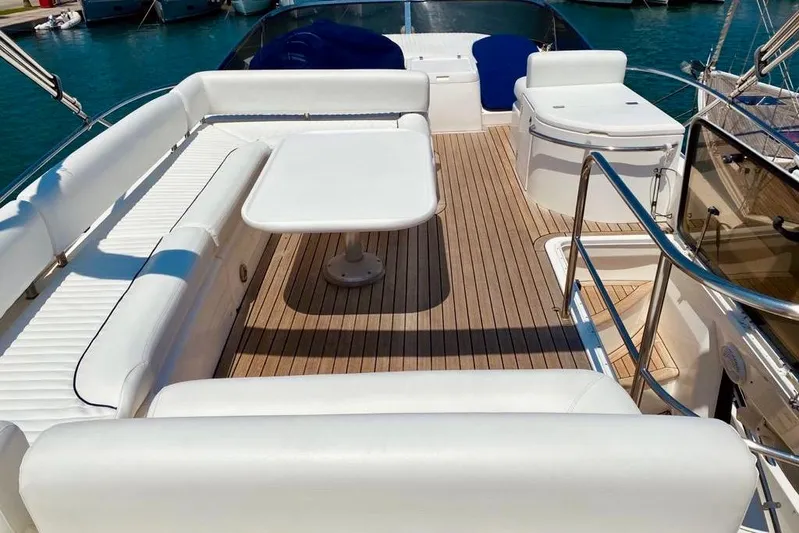 Yacht Photos Pics Luxurious 2004 Sunseeker Manhattan 56 yacht deck with white seating and table.