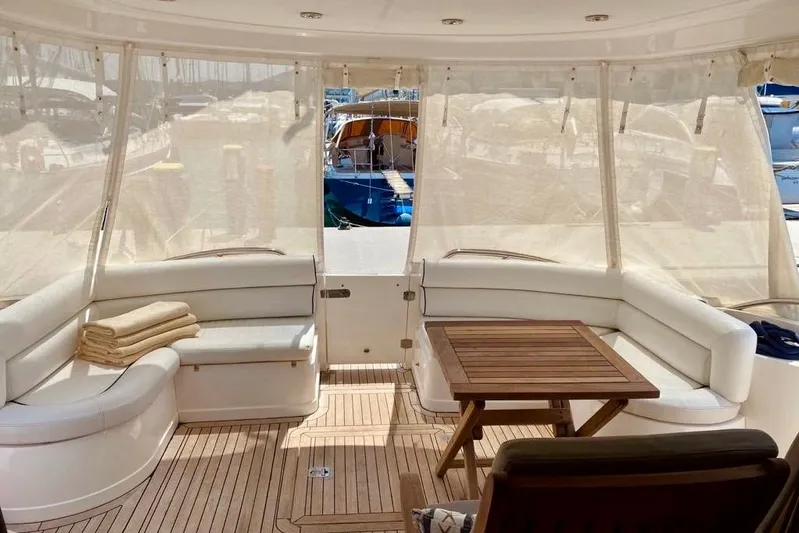  Yacht Photos Pics Luxurious 2004 Sunseeker Manhattan 56 yacht interior with elegant seating and wooden table.