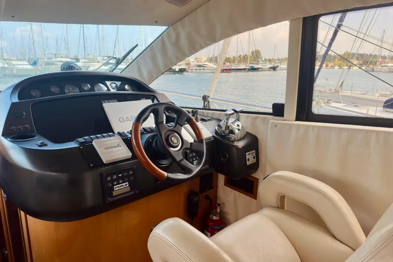  Yacht Photos Pics Helm of 2004 Sunseeker Manhattan 56 yacht with Garmin navigation system, marina view.