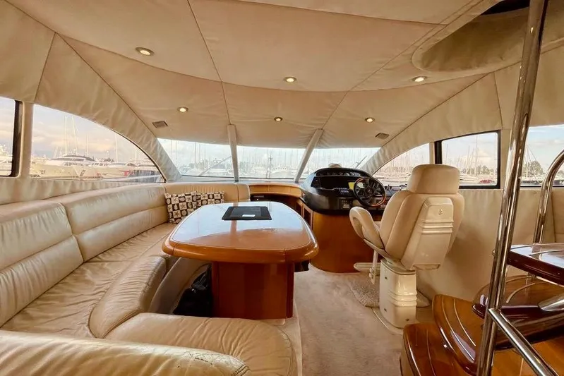  Yacht Photos Pics Luxurious interior of 2004 Sunseeker Manhattan 56 yacht with plush seating and helm.
