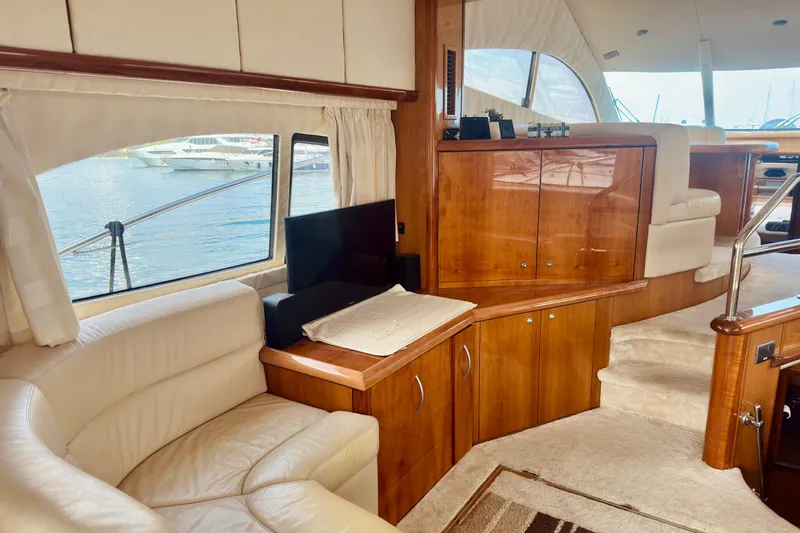  Yacht Photos Pics Luxurious interior of 2004 Sunseeker Manhattan 56 yacht with elegant wood finishes.