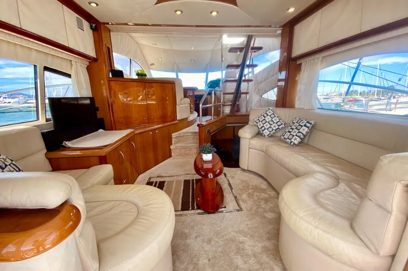  Yacht Photos Pics Luxurious interior of 2004 Sunseeker Manhattan 56 yacht with plush seating and elegant wood finishes.