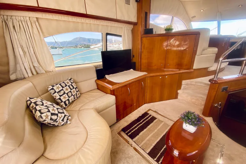  Yacht Photos Pics Luxurious interior of 2004 Sunseeker Manhattan 56 yacht with elegant seating and scenic view.
