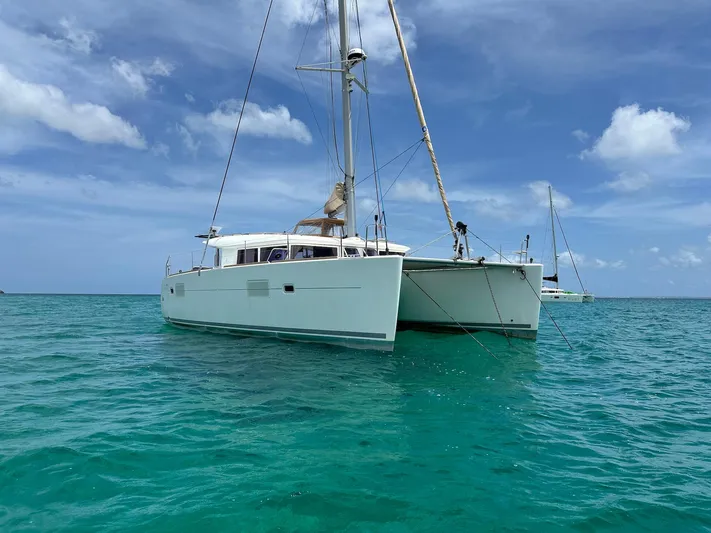  Yacht Photos Pics 2014 Lagoon 400 S2 catamaran sailing on clear turquoise waters under a blue sky.