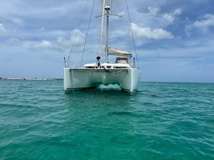  Yacht Photos Pics 2014 Lagoon 400 S2 catamaran sailing on clear turquoise waters under a blue sky.