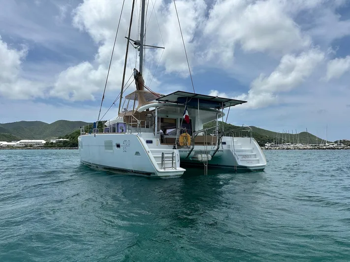  Yacht Photos Pics 2014 Lagoon 400 S2 catamaran sailing on calm waters under a cloudy sky.