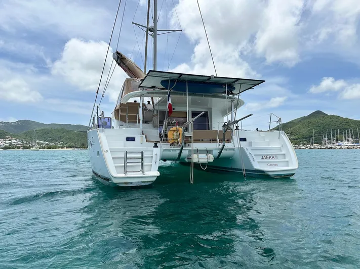  Yacht Photos Pics 2014 Lagoon 400 S2 catamaran on turquoise water, with scenic coastal backdrop.