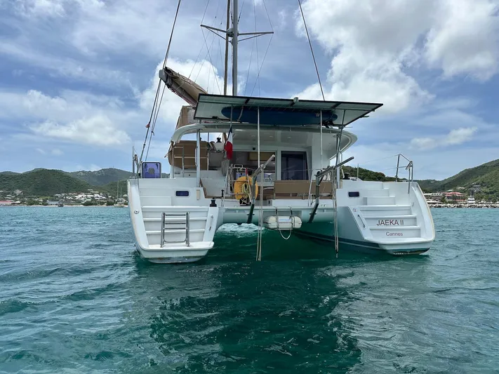  Yacht Photos Pics 2014 Lagoon 400 S2 catamaran on water, scenic coastal backdrop.