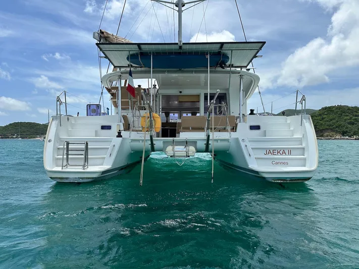  Yacht Photos Pics 2014 Lagoon 400 S2 catamaran on turquoise water, rear view, clear sky.