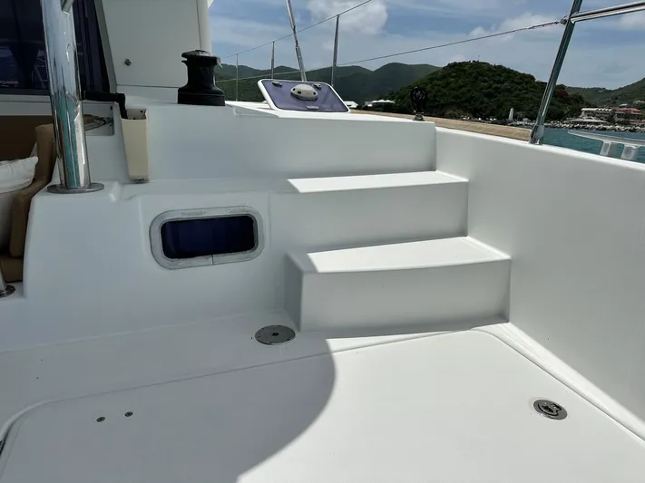  Yacht Photos Pics Steps on a 2014 Lagoon 400 S2 catamaran deck, with scenic coastal view.