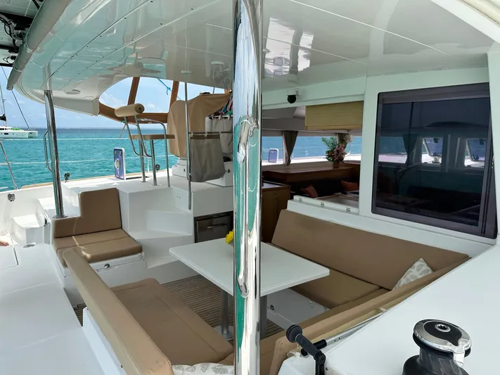  Yacht Photos Pics 2014 Lagoon 400 S2 catamaran interior with seating area, table, and ocean view.