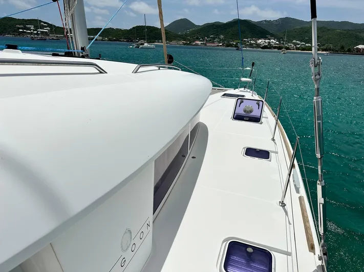  Yacht Photos Pics 2014 Lagoon 400 S2 catamaran on turquoise water with scenic island backdrop.