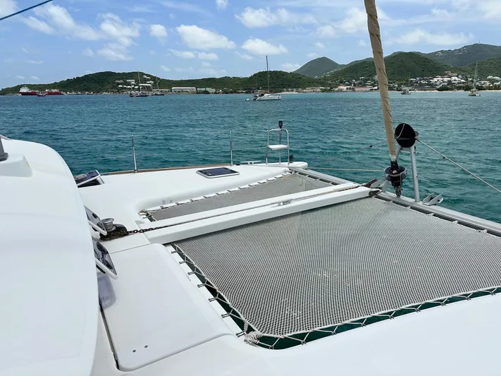  Yacht Photos Pics 2014 Lagoon 400 S2 catamaran on tranquil blue waters with scenic island backdrop.