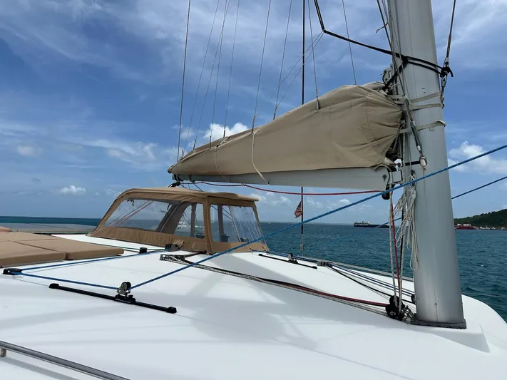  Yacht Photos Pics 2014 Lagoon 400 S2 catamaran sailing on a clear blue sea under a sunny sky.