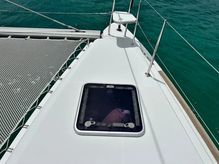  Yacht Photos Pics 2014 Lagoon 400 S2 catamaran deck with hatch and netting over turquoise water.