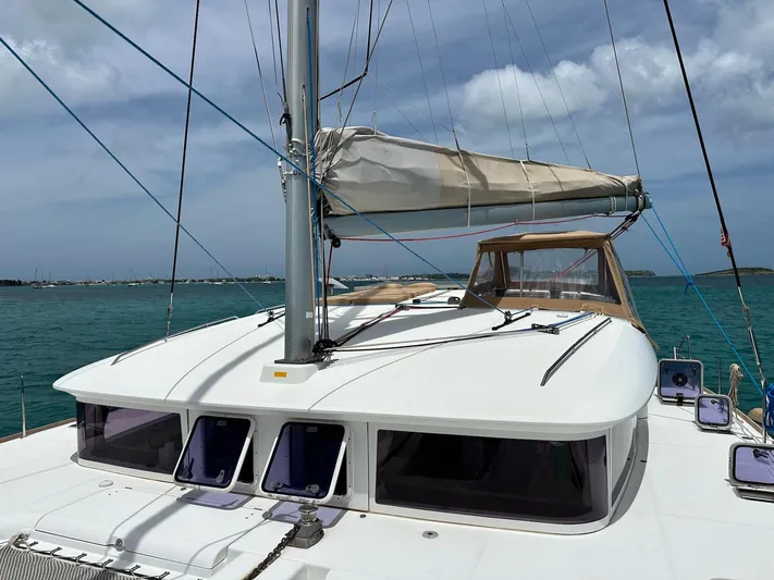  Yacht Photos Pics 2014 Lagoon 400 S2 catamaran on calm blue waters under a cloudy sky.