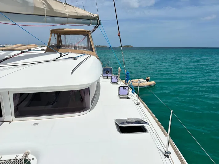  Yacht Photos Pics 2014 Lagoon 400 S2 catamaran on turquoise sea, clear sky, and distant island view.