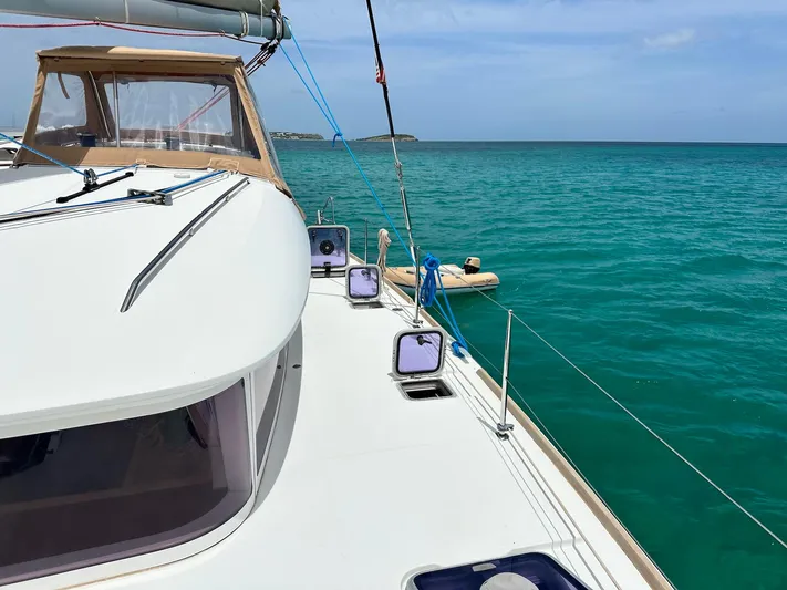  Yacht Photos Pics 2014 Lagoon 400 S2 catamaran sailing on turquoise sea with clear skies.