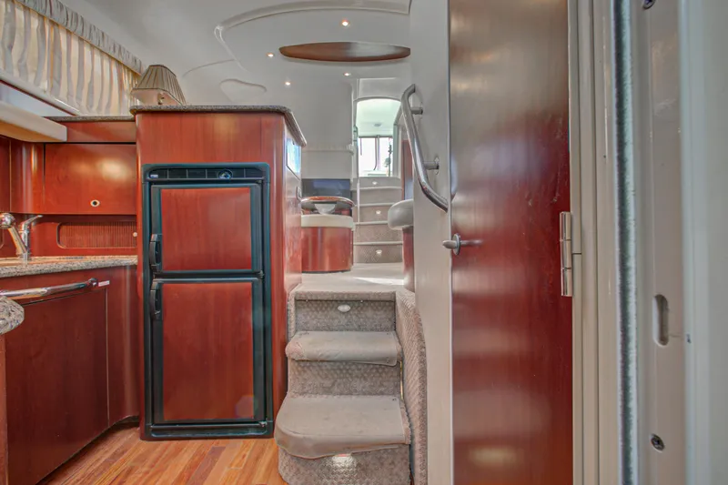 Bula Bula Yacht Photos Pics Interior of 2006 Sea Ray 40 Motor Yacht with wooden cabinetry and carpeted stairs.