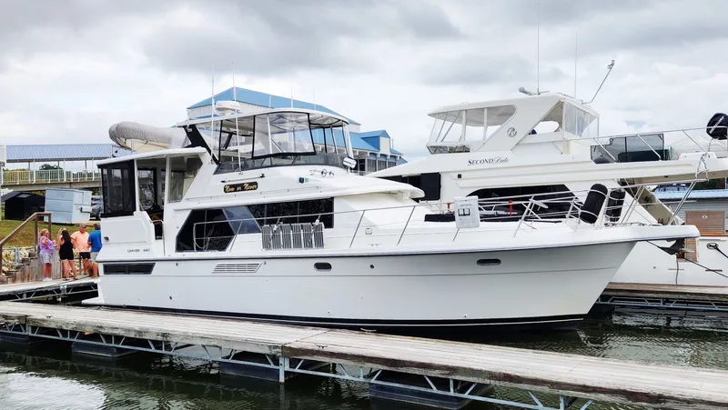 Now Or Never Yacht Photos Pics 1995 Carver 440 Aft Cabin Motor Yacht docked at marina with people nearby.