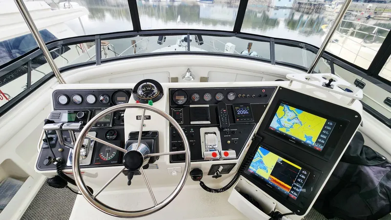 Now Or Never Yacht Photos Pics 1995 Carver 440 Aft Cabin Motor Yacht helm with navigation screens and controls.