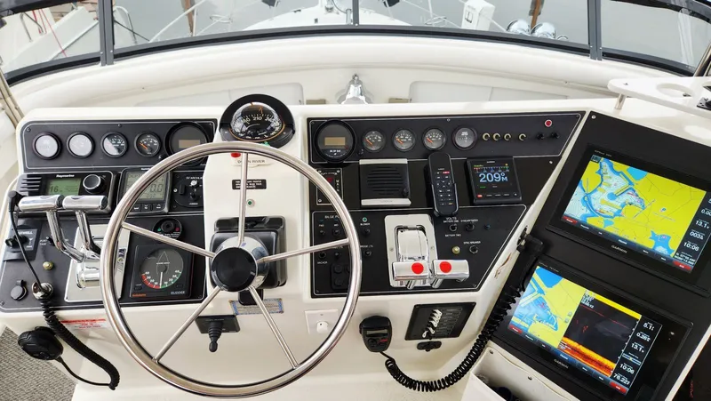 Now Or Never Yacht Photos Pics 1995 Carver 440 Aft Cabin Motor Yacht helm with navigation screens and controls.