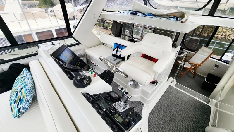 Now Or Never Yacht Photos Pics Interior of 1995 Carver 440 Aft Cabin Motor Yacht with helm and seating area.