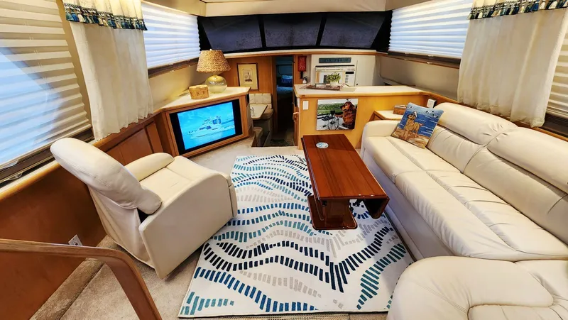 Now Or Never Yacht Photos Pics Luxurious interior of 1995 Carver 440 Aft Cabin Motor Yacht with plush seating and modern decor.