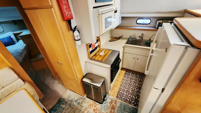 Now Or Never Yacht Photos Pics 1995 Carver 440 Aft Cabin Motor Yacht kitchen with appliances and cozy interior.