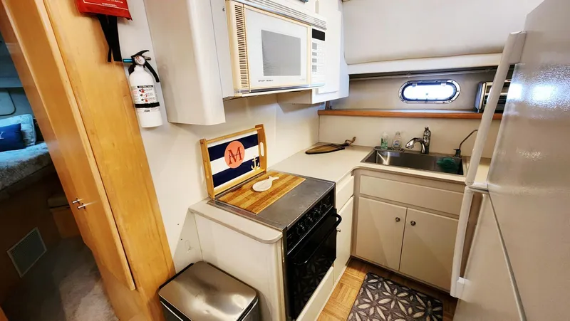 Now Or Never Yacht Photos Pics Compact kitchen in 1995 Carver 440 Aft Cabin Motor Yacht with appliances and sink.