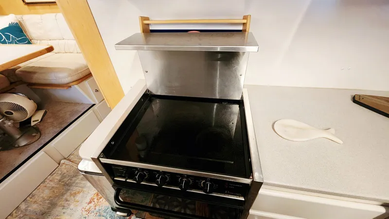 Now Or Never Yacht Photos Pics 1995 Carver 440 Aft Cabin Motor Yacht kitchen with stove and countertop.