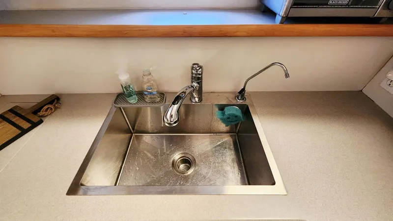 Now Or Never Yacht Photos Pics Stainless steel sink in 1995 Carver 440 Aft Cabin Motor Yacht kitchen.