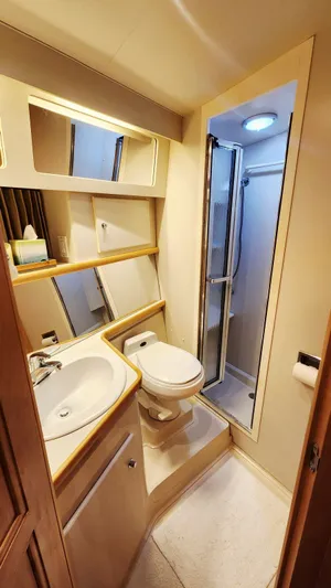 Now Or Never Yacht Photos Pics 1995 Carver 440 Aft Cabin Motor Yacht bathroom with shower, sink, and toilet.