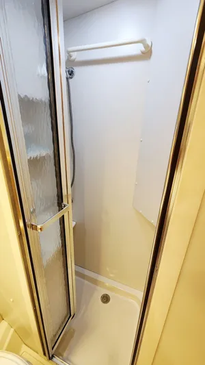 Now Or Never Yacht Photos Pics Shower area in 1995 Carver 440 Aft Cabin Motor Yacht with glass door and white interior.