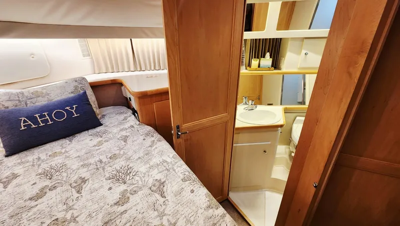 Now Or Never Yacht Photos Pics 1995 Carver 440 Aft Cabin Motor Yacht interior with cozy bed and private bathroom.